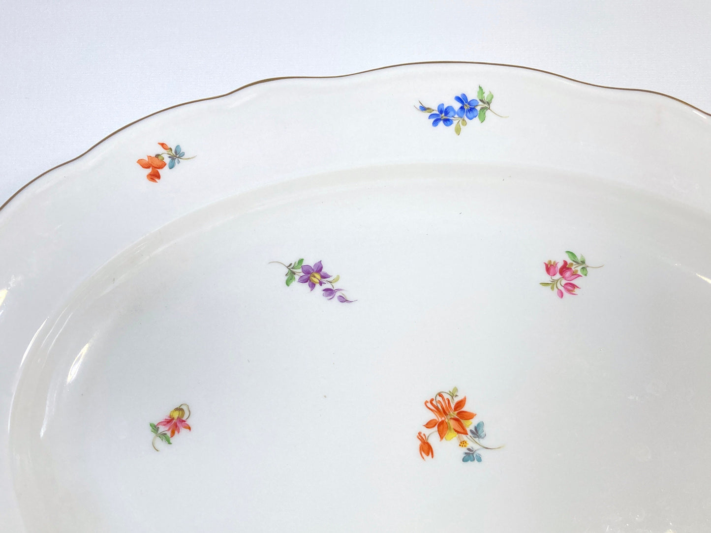 large Meissen oval platter decorated with scattered flowers and gilt rim, 16.5 inches x 12 inches, 1950s